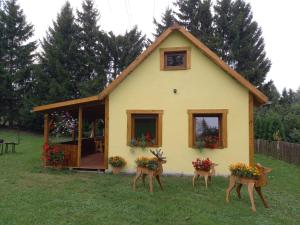 a house with two deer statues in front of it at Agroturystyka pod świerkami in Ryn +6 photos