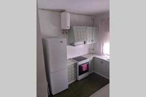 a kitchen with a white refrigerator and a stove at Villa Carmen - Chalet privado con piscina, jardín y barbacoa in Alcossebre