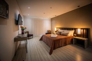 Ένα ή περισσότερα κρεβάτια σε δωμάτιο στο Quinta das Oliveiras Turismo Rural