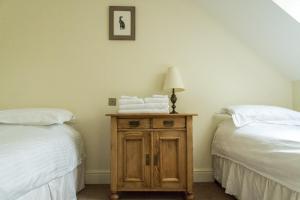 a room with two beds and a table with towels at Sedlescombe Golf Hotel in Sedlescombe