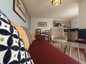 a living room with a couch and a table at Reflets de la Mer... in Plomodiern