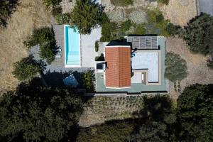 an overhead view of a house with a swimming pool at Tessera Villa, a Serene Escape in Nature with Pool, By ThinkVilla in Spílion