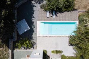 an overhead view of a swimming pool at Tessera Villa, a Serene Escape in Nature with Pool, By ThinkVilla in Spílion