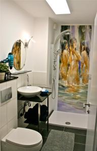 a bathroom with a sink and a shower with a painting at Eifel REBEIGE Gerolstein in Kopp