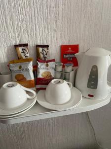 a shelf with a tea pot and cups on it at Parlors Hall Hotel in Bridgnorth