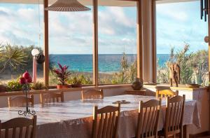 a dining room with a table and a view of the ocean at Theresia's in Porto Santo