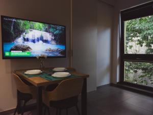 a dining room table with a television on it at Apartamenty Dworcowa 45 in Gliwice