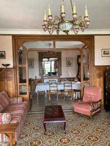 sala de estar con mesa y lámpara de araña en Domaine des Thomins, en Cisai-Saint-Aubin