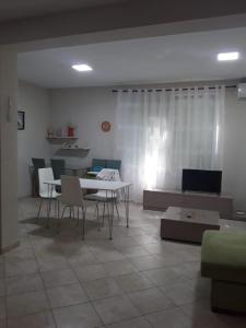 a living room with a table and a couch at A beautiful Beach house Marea Resort in Golem