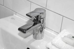 a bathroom sink with a faucet in a bathroom at Kings Arms Hotel in Berkhamsted