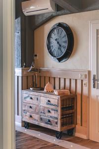 a clock on the wall above a dresser in a room at Lütt Haven in Barth