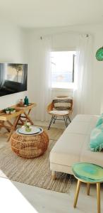 a living room with a bed and a table at Suit Mar y Sol in Cala Ratjada