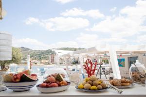 a table topped with bowls of fruit on a balcony at FURANO BAHARI in Agropoli