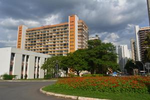 a large building with a lot of flowers in front of it at Garvey Park Hotel in Brasilia