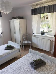 a bedroom with two beds and a window at Pensjonat HANYSEK in Góra Świętej Anny