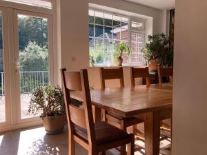 a dining room with a wooden table and chairs at Woodland Views in Milton Abbas