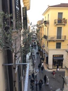 eine Gruppe von Menschen, die eine Straße zwischen Gebäuden entlang gehen in der Unterkunft A due passi da Giulietta-Casa Capuleti in Verona