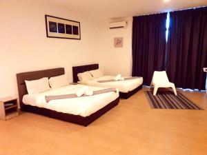 Postel nebo postele na pokoji v ubytování Bangi Perdana Hotel