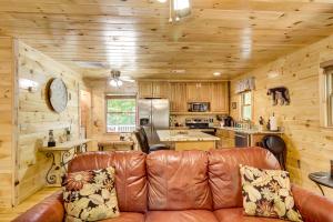 a living room with a leather couch in a kitchen at Moonshine Run in Blue Ridge