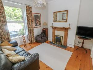 a living room with a couch and a fireplace at Hawthorn House in Pembroke