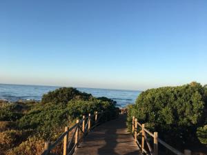 a path to the beach with the ocean in the background at Marbella Deluxe Rooms in Royal Cabopino Townhouse in Marbella