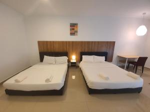 Postel nebo postele na pokoji v ubytování Bangi Perdana Hotel