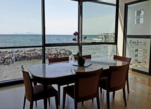 a table and chairs with a view of the ocean at Casa Rossa 1888 in Torre del Greco