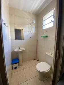 a bathroom with a toilet and a sink at Pousada J.C. Cazeri in Santos +44 photos