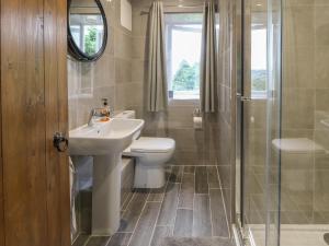 a bathroom with a sink and a toilet and a shower at Hill Top Cottage in Keighley +18 photos
