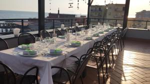 a long table with plates and glasses on a balcony at Casa Rossa 1888 in Torre del Greco +20 photos
