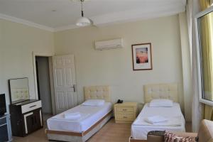 Łóżko lub łóżka w pokoju w obiekcie Prestij Apart Hotel