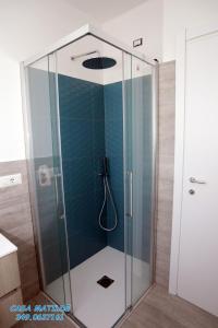 a shower with a glass door in a bathroom at Casa Matilde in Calasetta