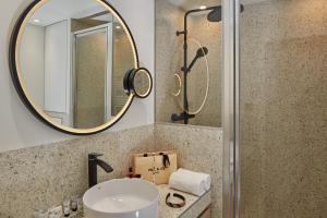 a bathroom with a sink and a mirror at PEPPER & PAPER Apartments in Paris