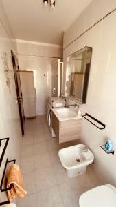 a bathroom with a sink and a toilet and a mirror at Matera Belvedere in Matera