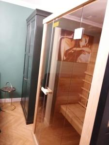 a glass shower in a room with a staircase at Luksusowy Apartament nad morzem in Gdańsk