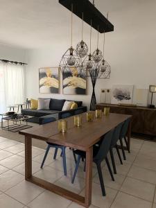 a living room with a table and a couch at 2 Bedrooms 3 Bath apt. @ La Marina, Casa De Campo in La Romana