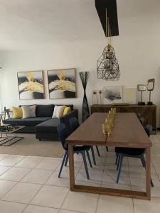 a living room with a table and a couch at 2 Bedrooms 3 Bath apt. @ La Marina, Casa De Campo in La Romana