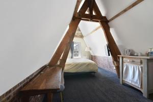 a bedroom with a bed in a attic at La cour des grands in Arras