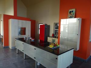 a large kitchen with a counter and a refrigerator at Ungabona in East London
