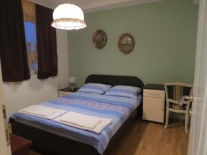 a bedroom with a bed and a chandelier at Dona Apartments in Ohrid