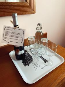 a bottle of wine on a tray with wine glasses at Casa Machado in Montalegre