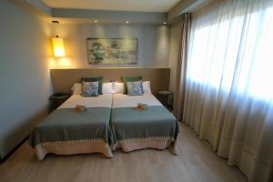 Postel nebo postele na pokoji v ubytování Hotel Torre de Núñez