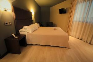 Postel nebo postele na pokoji v ubytování Hotel Torre de Núñez