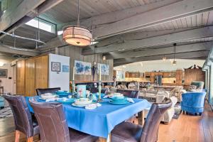 a dining room with a blue table and chairs at Waterfront House with Glacial Views - Near Downtown! in Juneau