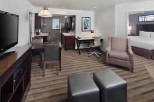 a hotel room with a bed and a desk at Hyatt House Dallas Las Colinas in Irving
