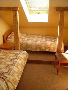 a bedroom with two bunk beds and a window at Vana Postimaja Accommodation in Suure-Jaani