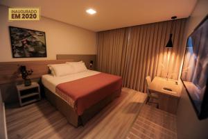 Tempat tidur dalam kamar di Figueiras Hotel & Eventos