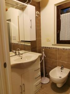 a bathroom with a sink and a toilet at Bed & Breakfast Cà Riccio in Macerata Feltria
