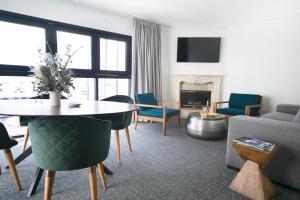 a living room with a table and chairs and a fireplace at Bellanca Hotel in Avalon