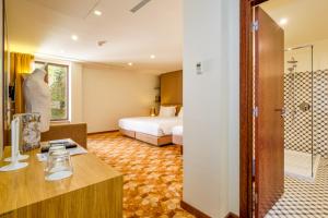 a hotel room with a bed and a shower at Sintra Boutique Hotel in Sintra